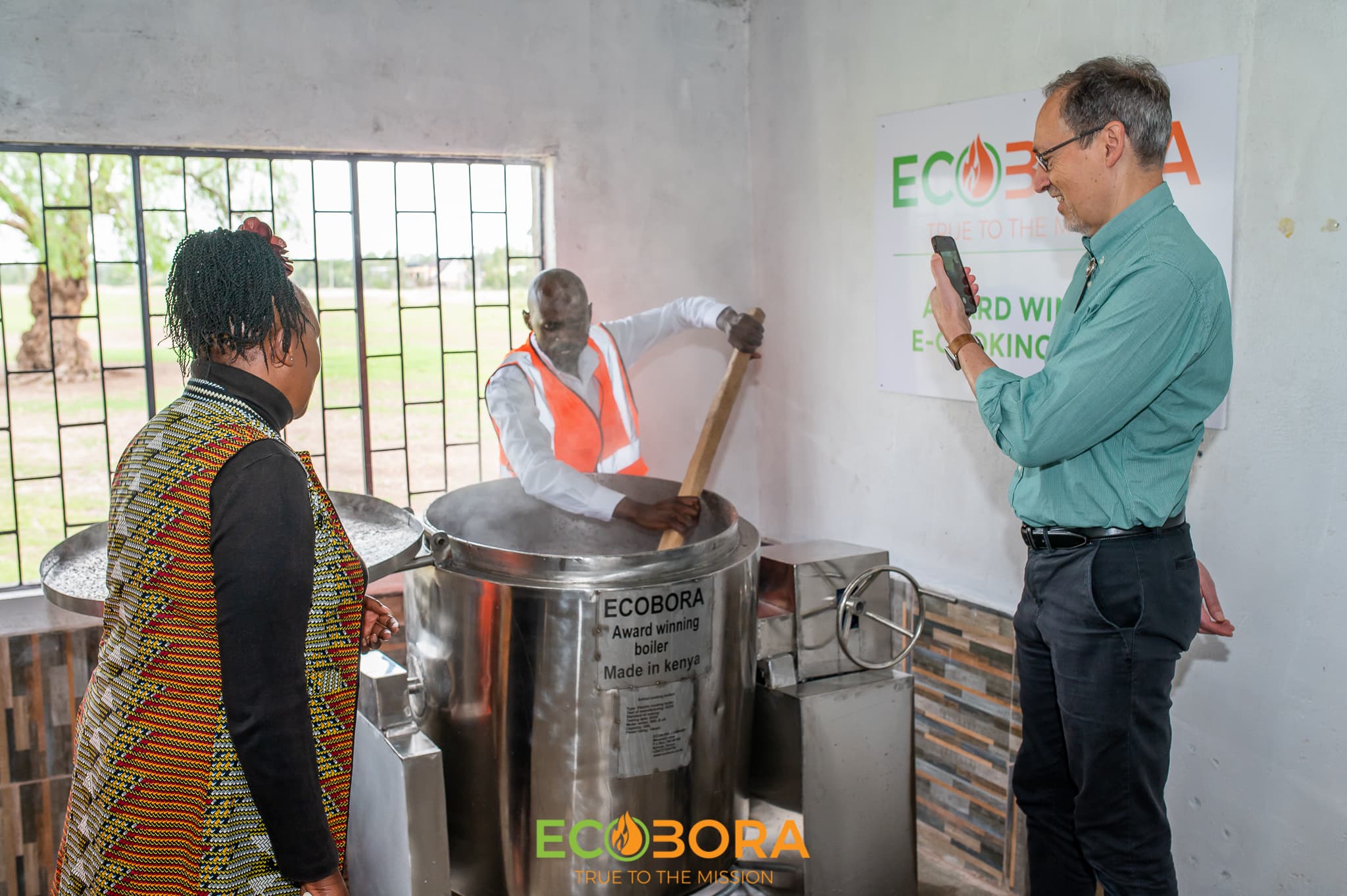 Cooks preparing a meal on clean electric cookstoves in a school kitchen